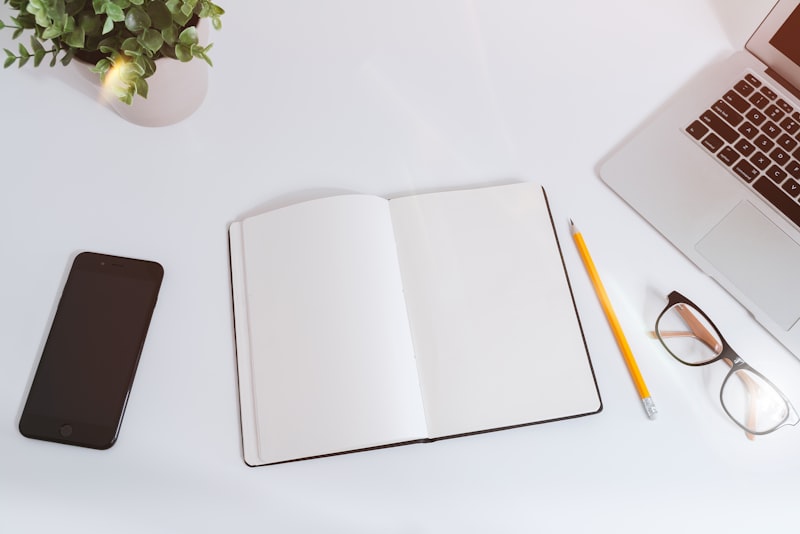 A freelancer sitting at a desk reviewing notes during a video call with a client.